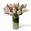 This tulip arrangement is light pink parrot tulips in a glass vase.
