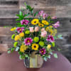 Bright and uplifting garden style arrangement, full of colorful wildflowers in an