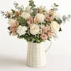 Bouquet de roses, carnation, limonium and peach peruvian lilies, and other greenery.