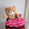 A gift set featuring a soft teddy bear inside a black heart-shaped
