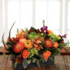 Exquisite garden table centerpiece featuring garden roses, orange protea, berry stock, garden
