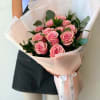 Dozen Pink Roses with greenery and decorative wrapping paper. All bouquets come