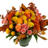 Roses, calla lilies, spray roses, celosia, ranunculus and more designed round, in