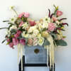 A romantic box arrangement filled with Roses, Lisianthus, and soft Scabiosa blooms.