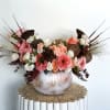 A stunning autumn centerpiece arranged in a metallic pumpkin vase, filled with