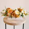Arrangement approximately measures 8 inches tall and 18 inches long with flowers.

Celebrate