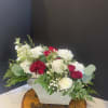 Beautiful fresh flowers in a metal sleigh. Spray roses, roses, stock, carations