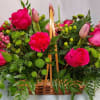 Handle Basket of lush greens, berries, lilies and roses.
