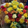 Bright yellow roses, spider mums, alstroemeria with red roses and red carnations.