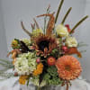 calla lilys, sunflowers, hydragea and sunset colors arranged in a low square