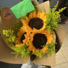 3 sunflowers wrapped with some solidago stems in a neutral colored wrap