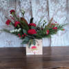 Celebrate the season! This traditional arrangement of red carnations or red roses