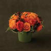Arrangement of brilliant orange and saffron-hued roses, bunches of petite spray roses