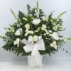 A traditional sympathy basket of all white florals to include Snapdragons, Roses