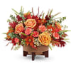 Modern Cooper Centerpiece brings fall to life with rich seasonal blooms. Artfully