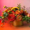 Harvest Blooms is a warm and radiant arrangement featuring rich oranges, sunny