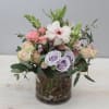 This arrangement is a mix of butterfly ranunculus, spray roses, and snapdragons
