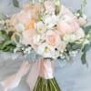 This bridal bouquet is soft and features textures of pale pink and
