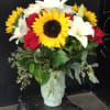 Sunflowers, roses, &amp; lilies in a vase