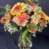 Our signature bouquet is filled with beautiful,  pink, orange and coral