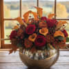 ​This vibrant, lush fall arrangement captures the warmth and richness of the