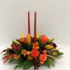 Beautiful centerpiece for the table of orange and bronze flowers mixed. 