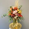 Autumn Harvest is designed in a tall clear glass vase filled with