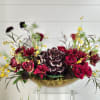 An airy thanksgiving centerpiece with Hydrangeas, roses, scabiosa, Oncidium orchids and more