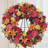 The Multicolor Bright Circle Funeral Wreath by DGM Flowers is a stunning