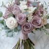This bridal bouguet features lavender and white rose with a touch of