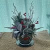 A holiday arrangement with a snow man top hat vase