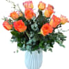 Bright and uplifting, 18 Free Spirit roses in a white tulip vase