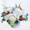 Experience the magic of winter with our Frosted Luxe floral arrangement, a