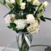 A breathtaking mix of premium white roses, white lilies and hydrangea