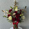 This captivating arrangement features radiant red Ecuadorian roses paired with elegant lilies