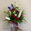 An assortment of red, white and blue flowers. 