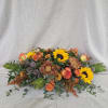 Bursting with the rich tones of autumn, this radiant centerpiece combines golden