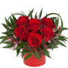 Unique and expressive arrangement of 6 lush red roses with greenery and