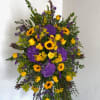 A beautiful standing spray with bold yellow and purple colors. Sure to
