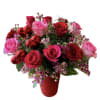 Red roses, pink roses, hot pink roses and wax flower designed in