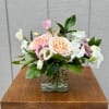 Cube arrangement consisting of peach roses, lisianthus, sweet peas, and greenery. 