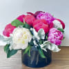 10 different colors of peonies in a brown glass vase