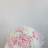 A cloud-like bouquet of blush and white hydrangeas, symbolizing love, joy, and