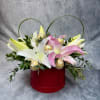 A delicate blend of fresh lilies and chocolate sticks , elegantly arranged