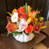 This gorgeous autumn arrangement is designed in a ceramic pumpkin perfect for
