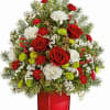his mini Christmas tree bouquet features white carnations, miniature red carnations, green