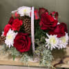 Red roses and red carnations with white mums and pine cones in