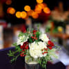 Celebrate the season with our stunning Snowberry Bliss floral arrangement, featuring a