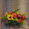 This dynamic fall centerpiece brings the autumn colors and textures to your