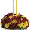 Happy yellow mums and a golden taper candle bring sunshine to your